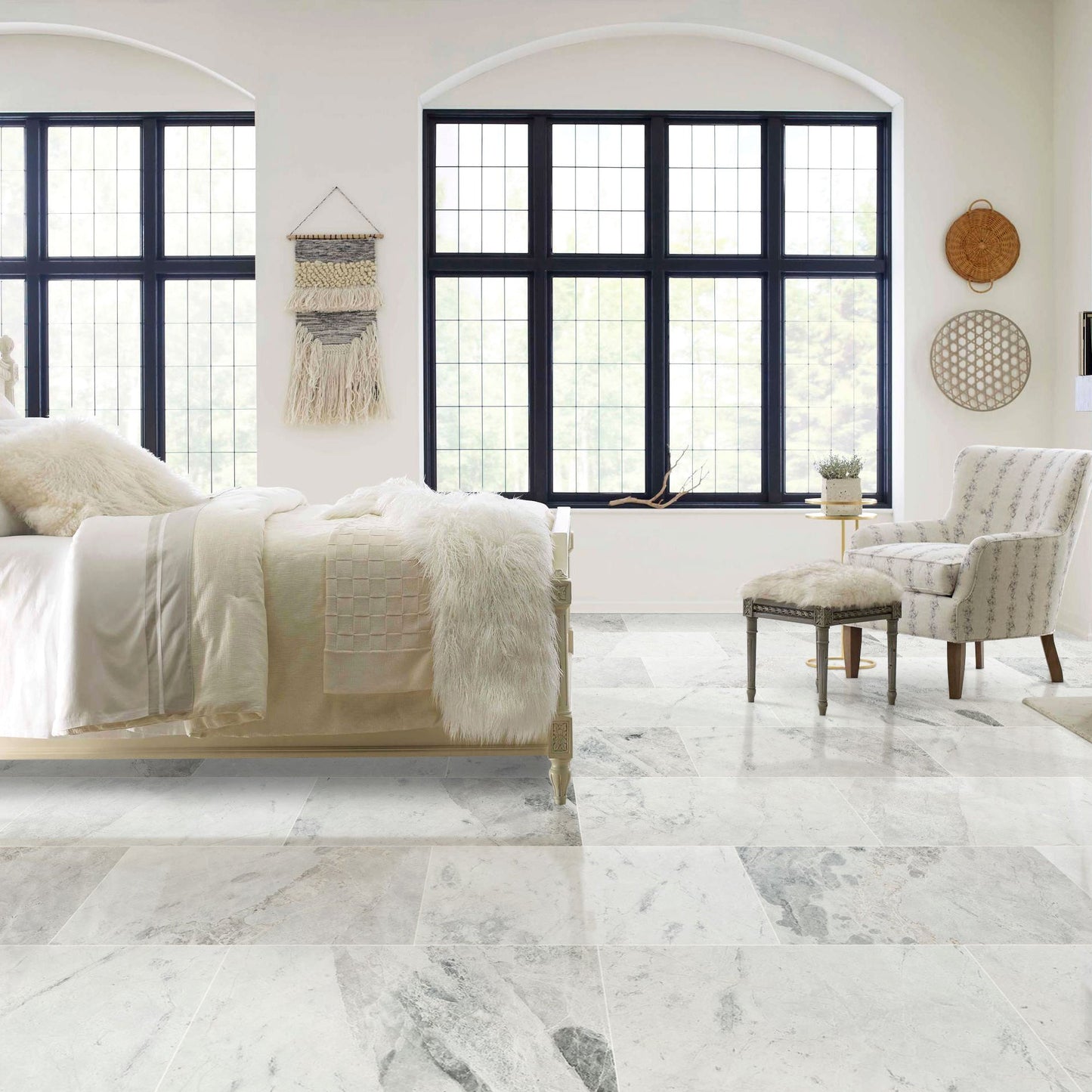 Modern bedroom with marble flooring, large windows, and neutral decor.