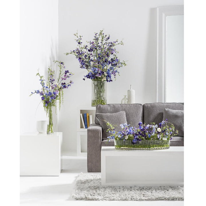 Artificial Faux Sweet Pea Arrangement in Ribbed Glass Vase  with several arrangements in the room