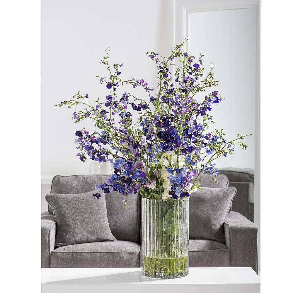 Artificial Faux Sweet Pea Arrangement in Ribbed Glass Vase in living room