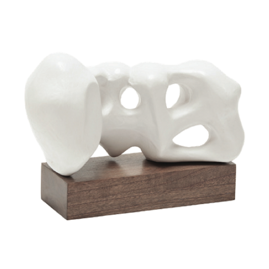 White abstract sculpture on a wooden base against a white background