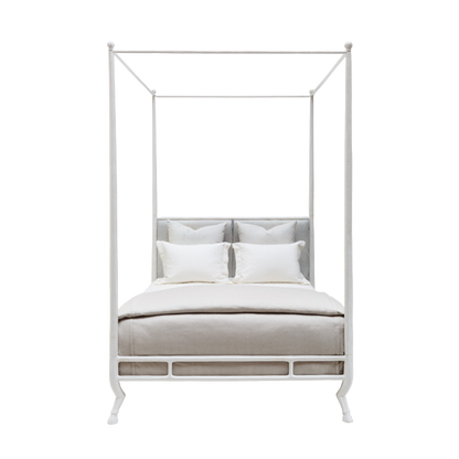 White metal canopy bed with bedding on a white background