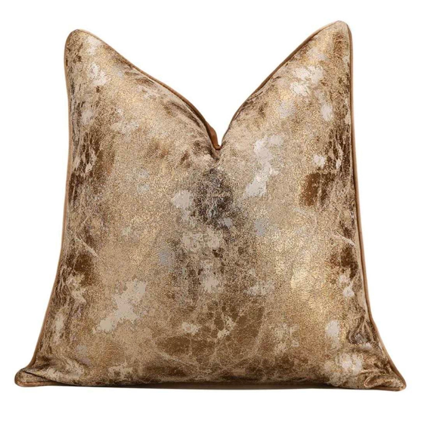 Gold and bronze patterned throw pillow on a white background