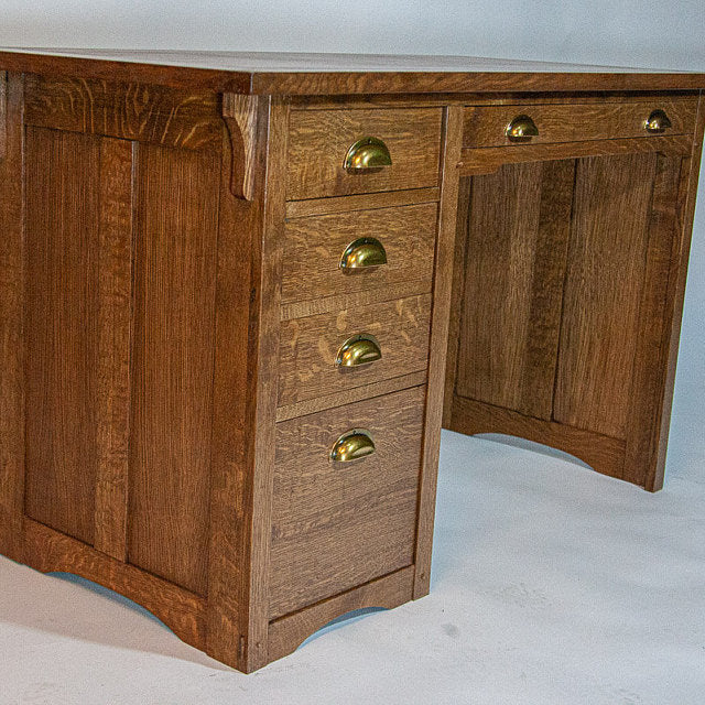 Wooden desk with gold handles on a white background