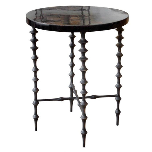 Decorative side table with unique spiky legs on a white background