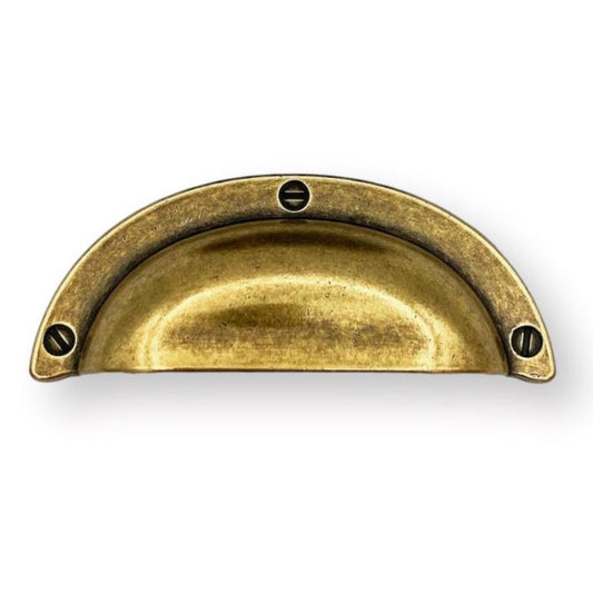 Brass drawer pull on a white background
