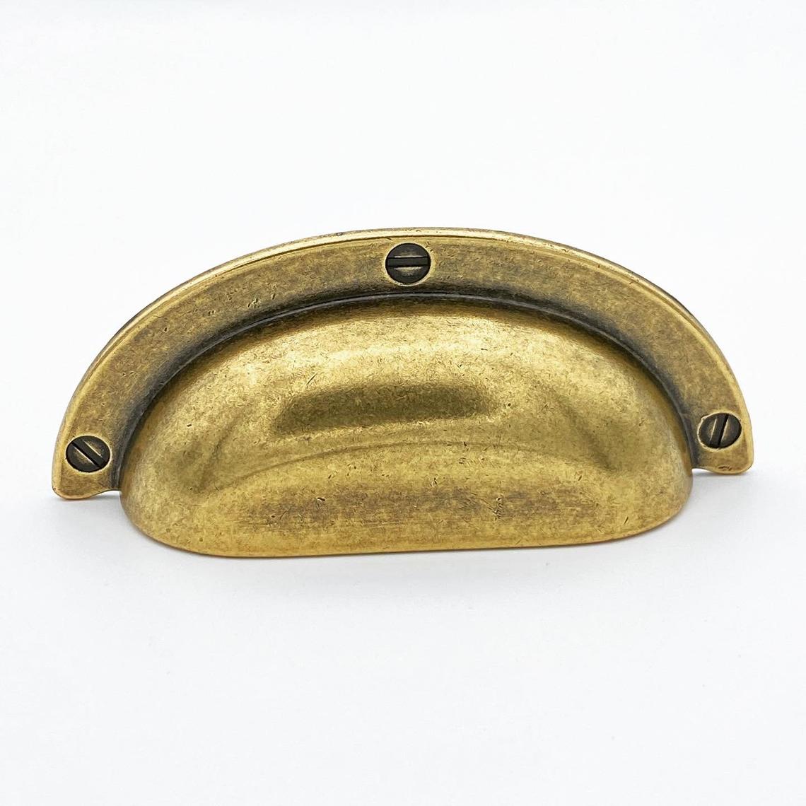 Brass cabinet handle on a white background