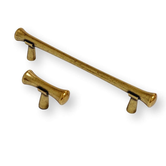 Pair of gold cabinet handles on a white background