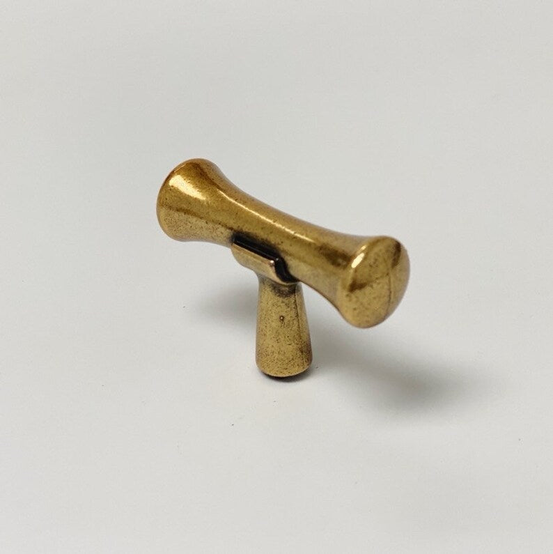 Brass-colored knob on a white background