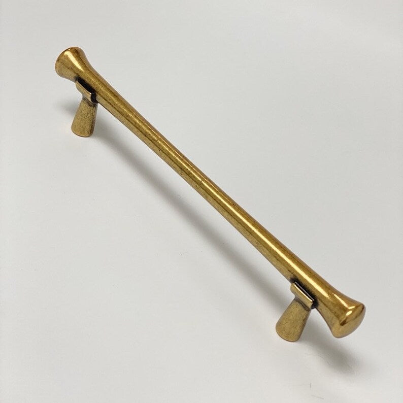 Gold metal handle on a white background