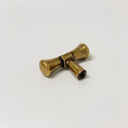 Bronze bow-shaped object on a white background