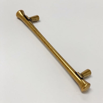 Gold metal rod with a curved end on a white background
