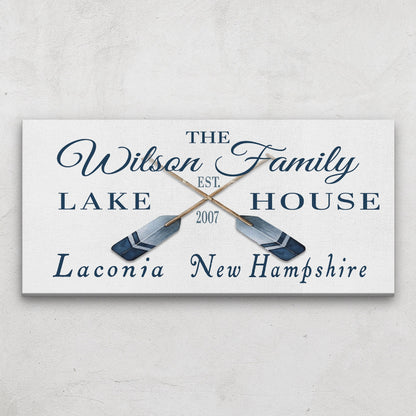 Personalized lake house sign with oar designs on a light gray background