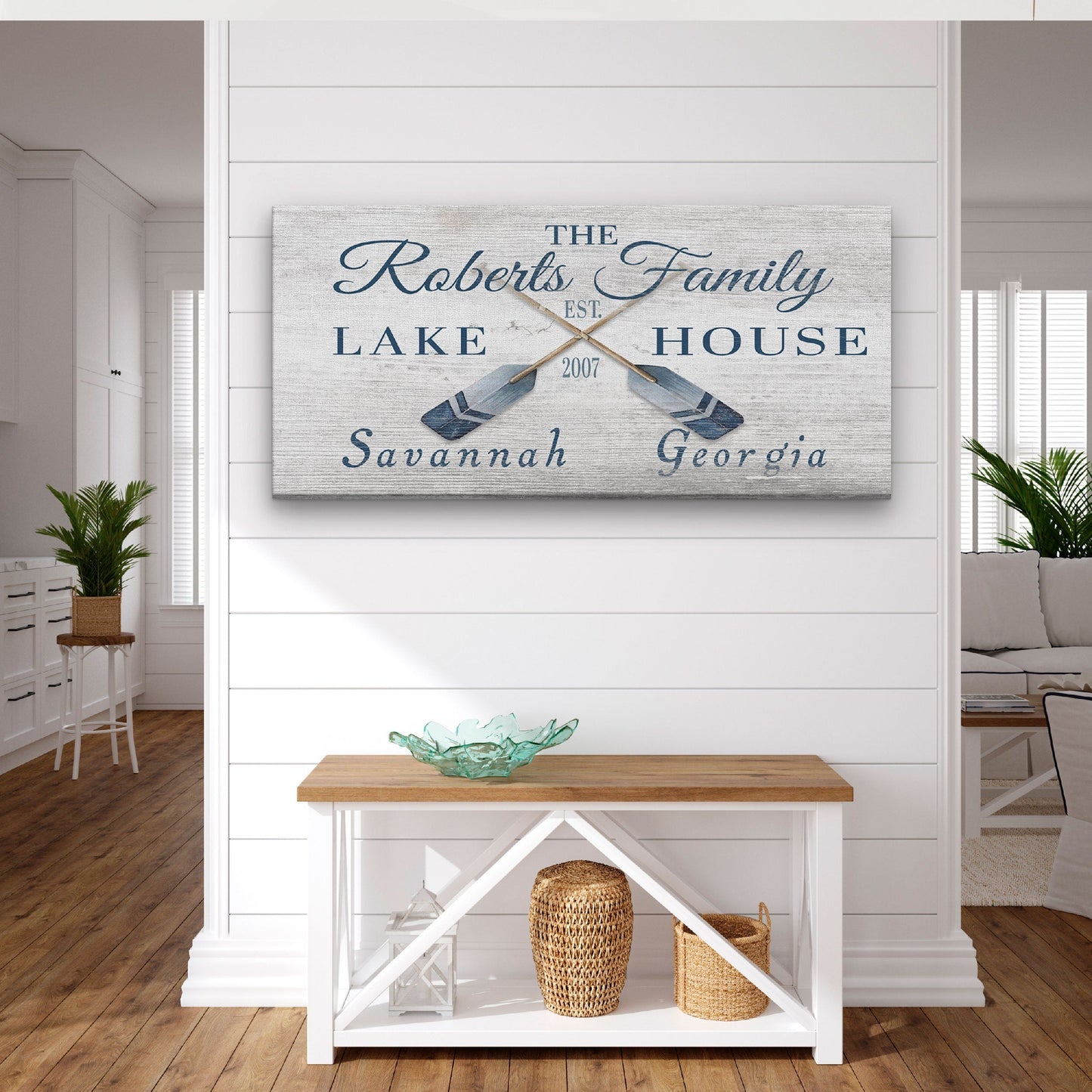 Decorative sign with 'The Roberts Family Lake House' on a wall in a home interior.