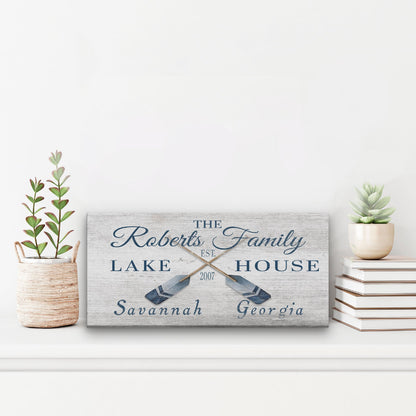 Personalized lake house sign with decorative elements on a white surface.
