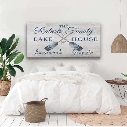 Bedroom with a decorative sign above the bed featuring 'The Roberts Family Lake House' text.
