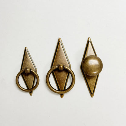 Three bronze door knockers on a white background