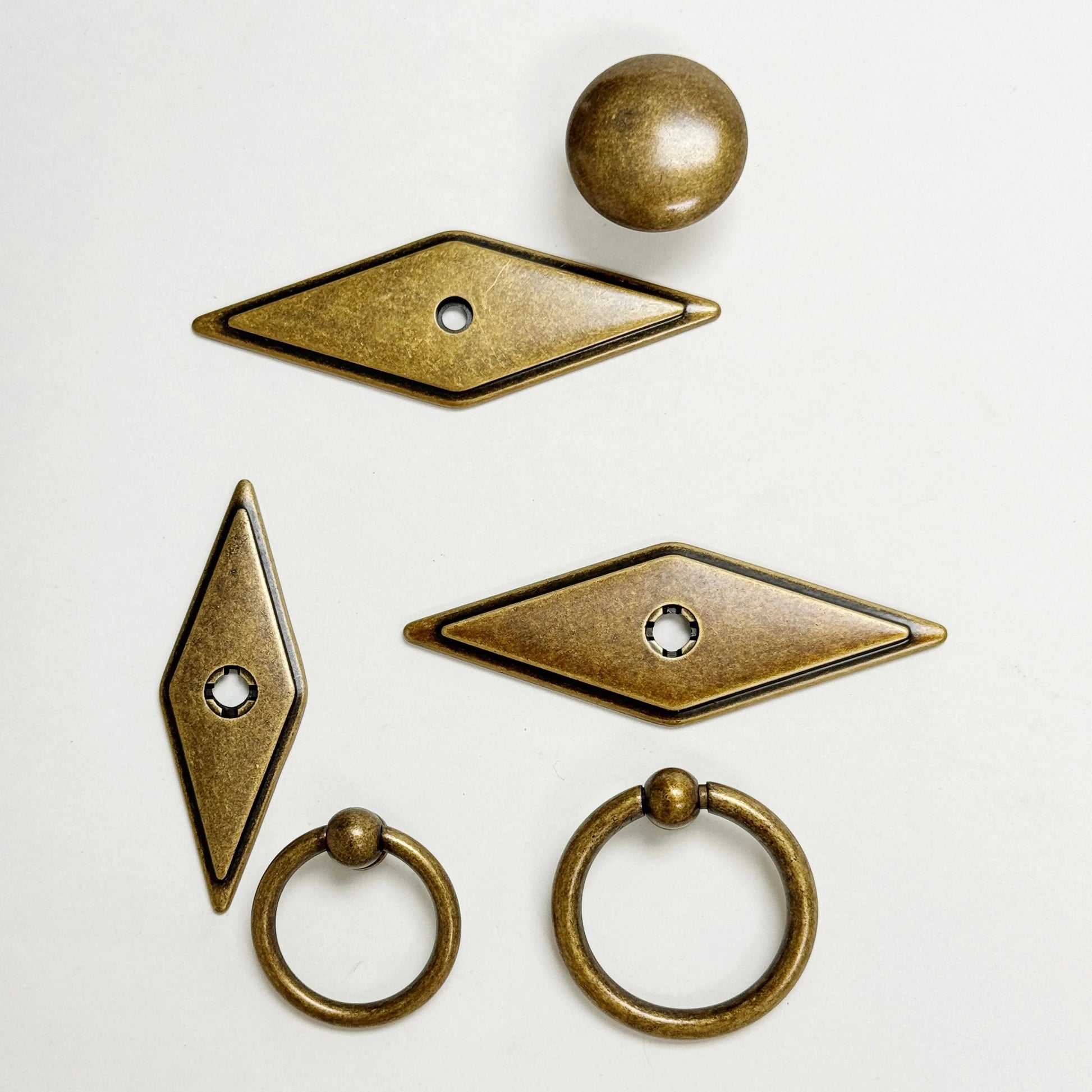 Set of bronze door handles and knobs on a white background