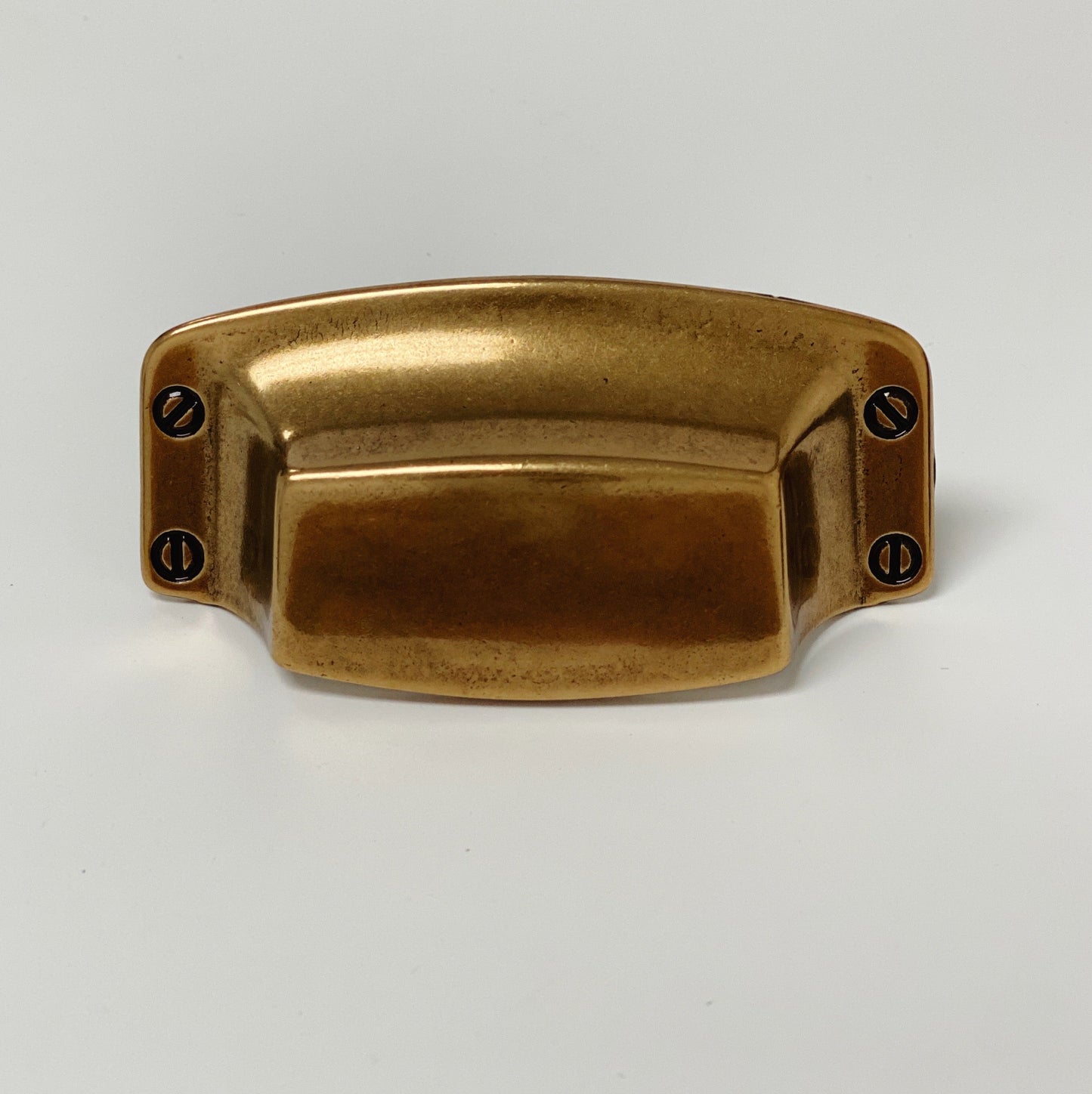 Brass drawer pull on a white background