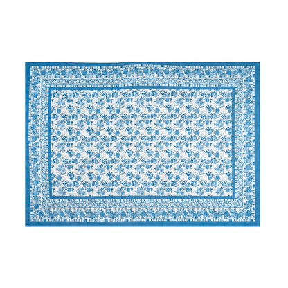 Floral patterned rug with blue border on a white background
