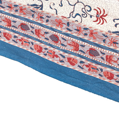 Close-up of a patterned fabric with red, blue, and white colors on a white background.