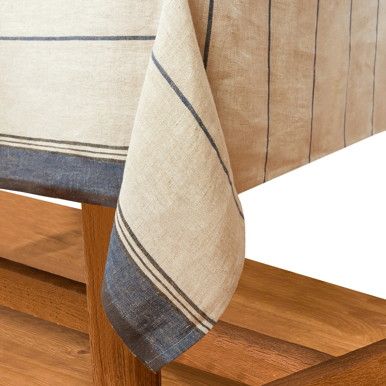 Striped tablecloth with blue and beige colors draped over a wooden chair.