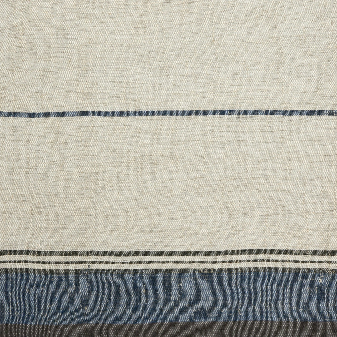 Textured fabric with horizontal blue stripes on a beige background