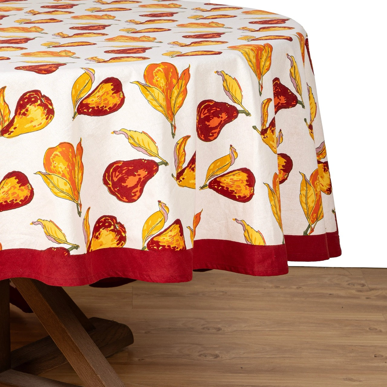 Tablecloth with autumn-themed design on a wooden table