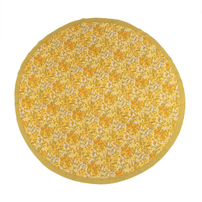 Round yellow rug with floral pattern on a white background