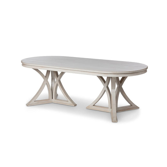 Oval dining table with a marble-like surface and X-shaped base on a white background