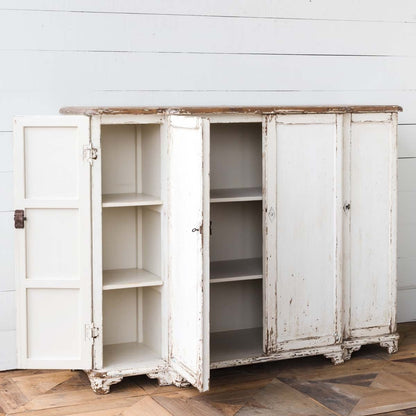 Vintage-style white cabinet with open doors on a wooden floor.