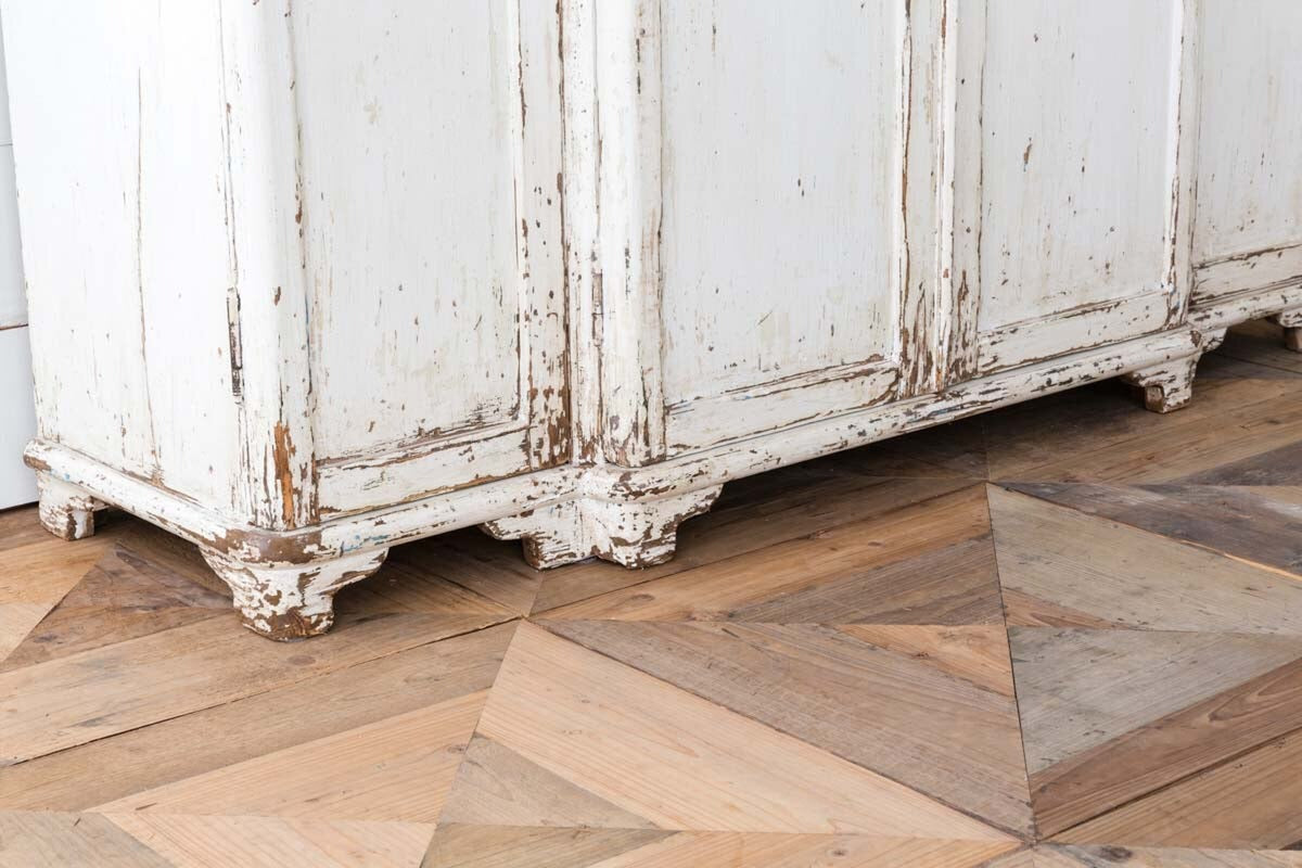 Weathered wooden cabinet on a parquet floor