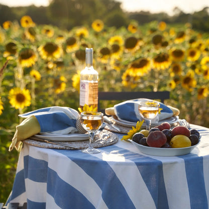 Table setting with wine and fruit in a sunflower field