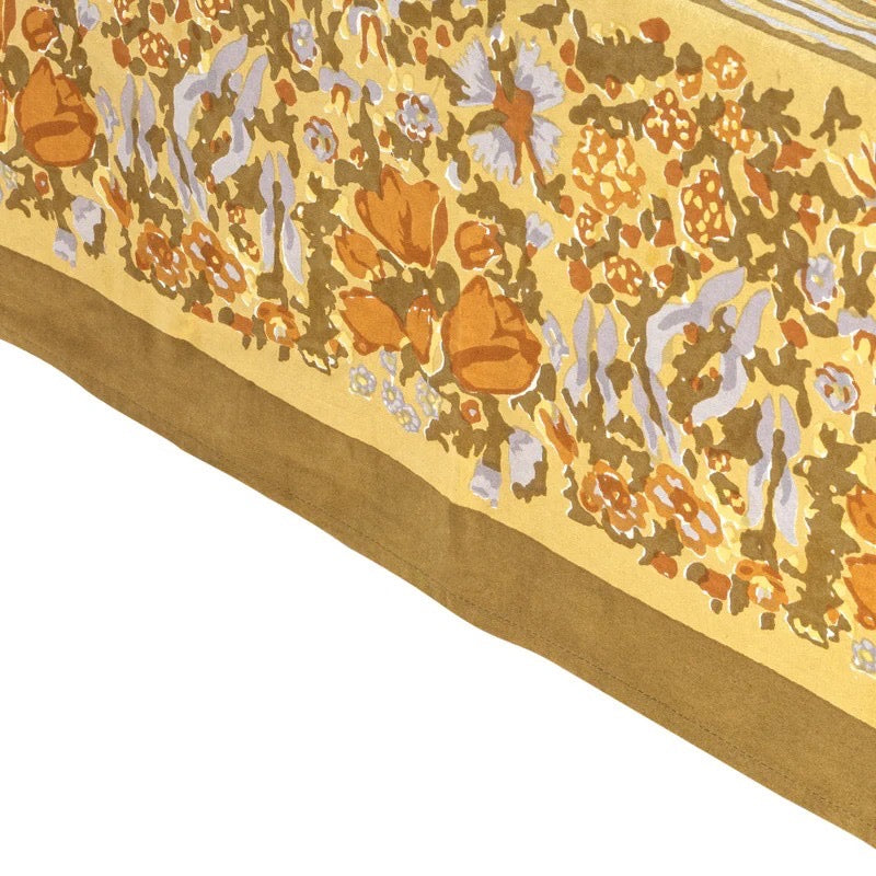 Close-up of a floral patterned fabric with a yellow background