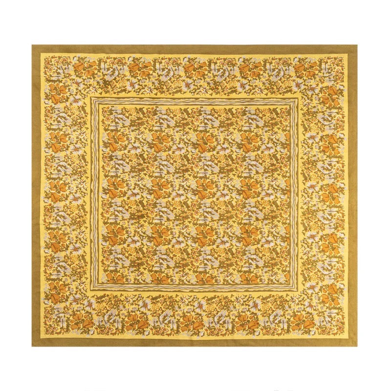 Floral patterned fabric square with a gold border on a white background
