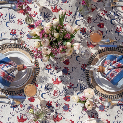Elegant table setting with floral centerpiece on a patterned tablecloth