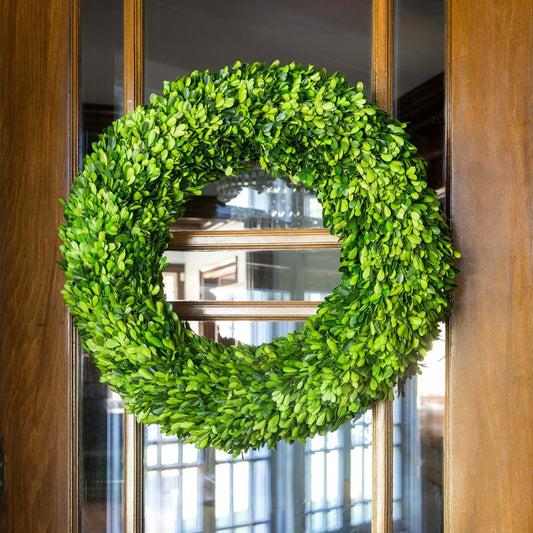 Green wreath on a wooden door with glass panels