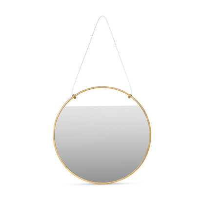 Round mirror with gold frame hanging on a white background