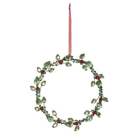Decorative wreath ornament with green leaves and red berries on a white background
