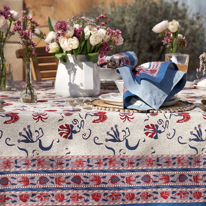 Elegant table setting with floral centerpiece on a patterned tablecloth