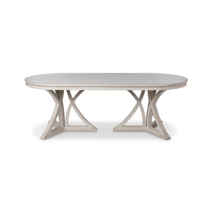 Round dining table with a light wood finish on a white background