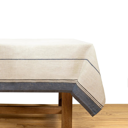 Beige tablecloth with blue stripes on a wooden table against a white background