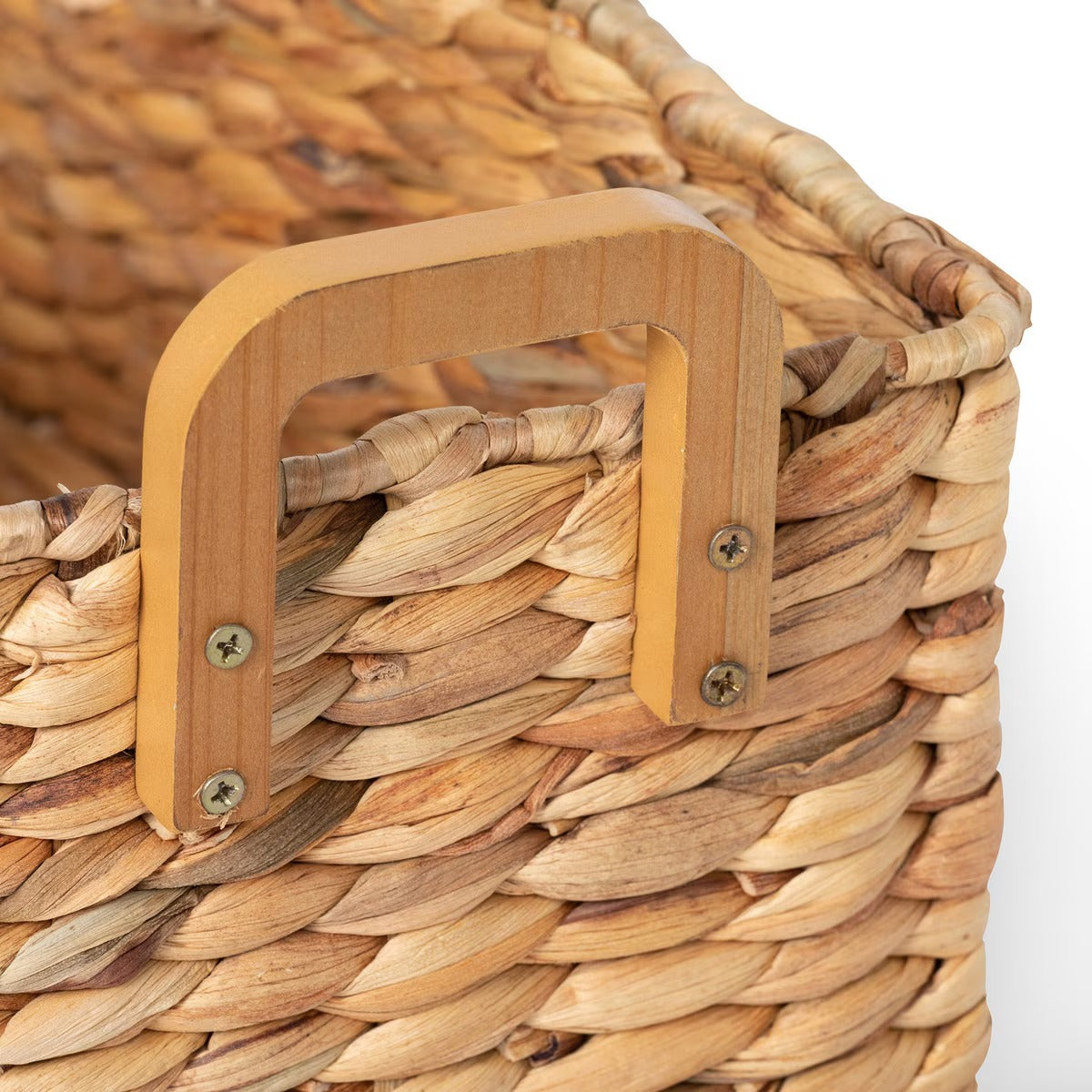 Close-up of a woven basket with a wooden handle on a white background
