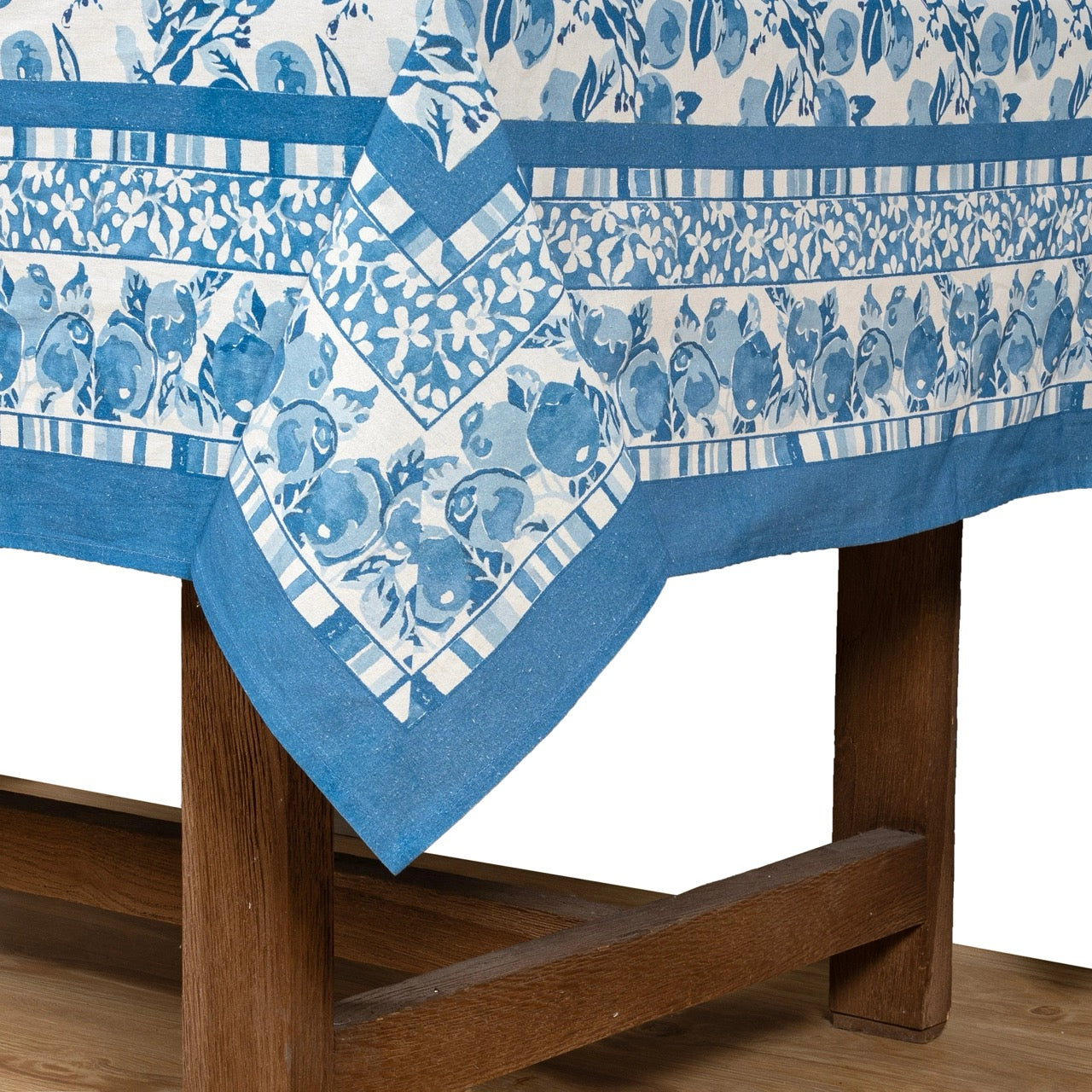 Blue and white patterned tablecloth on a wooden table