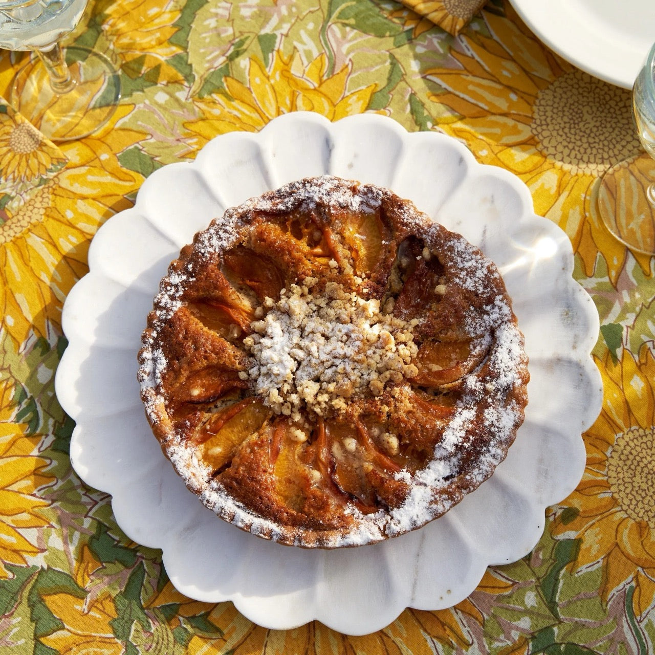 Apple pie on a decorative plate with a floral tablecloth