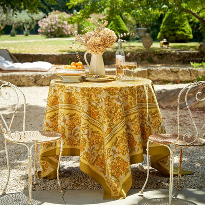 Outdoor table setting with a floral tablecloth in a garden