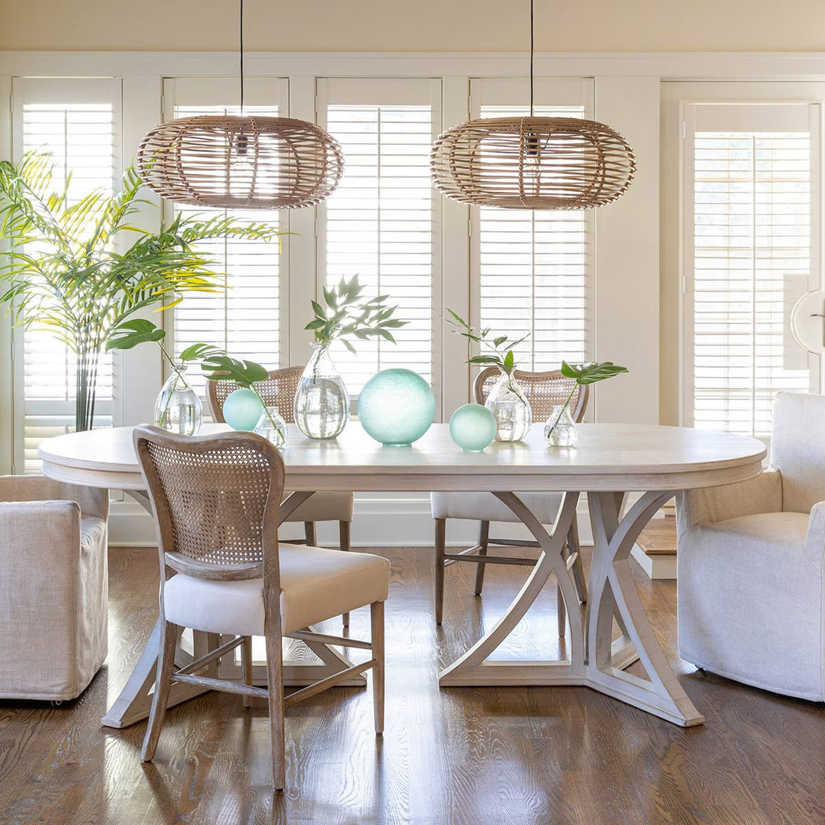Dining room with a round table, chairs, and decorative items.