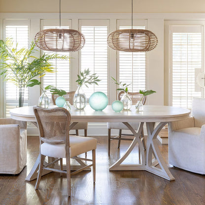 Dining room with a round table, chairs, and decorative items.
