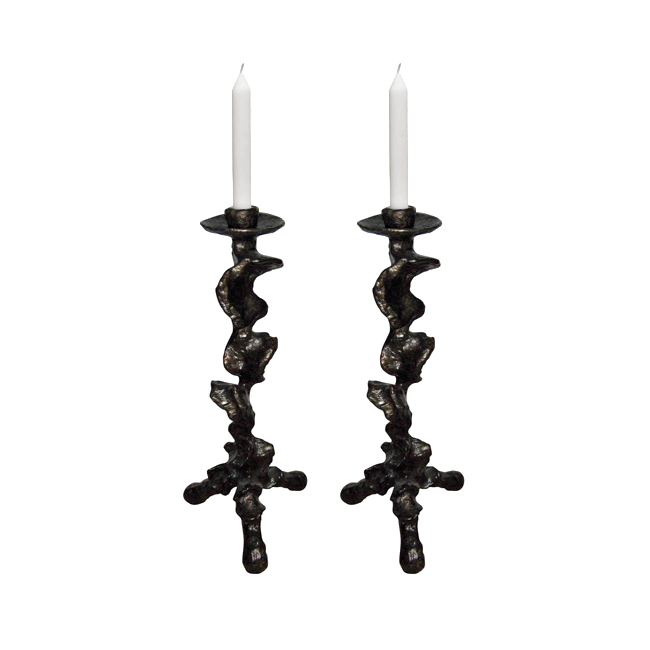 Two decorative candle holders with candles on a white background