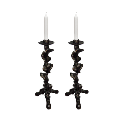 Two decorative candle holders with candles on a white background