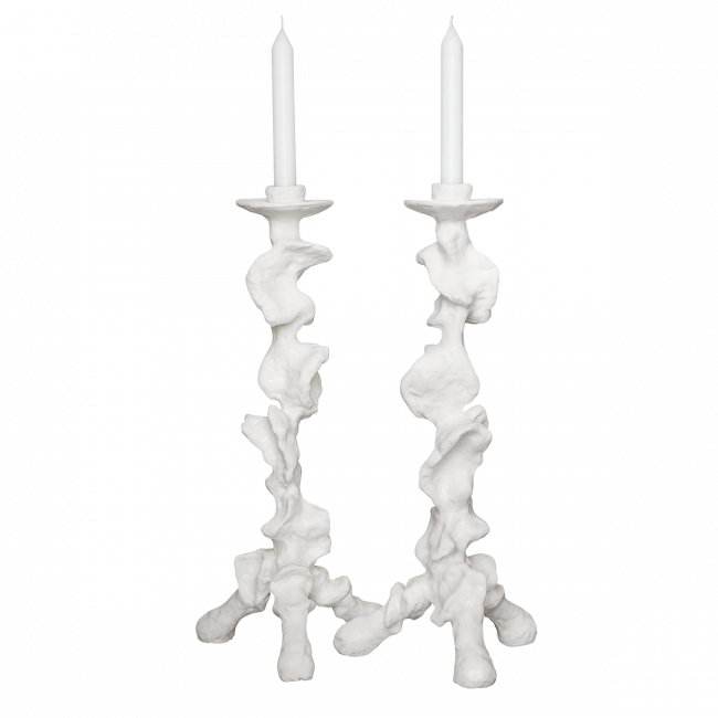 Two white candle holders with candles on a white background
